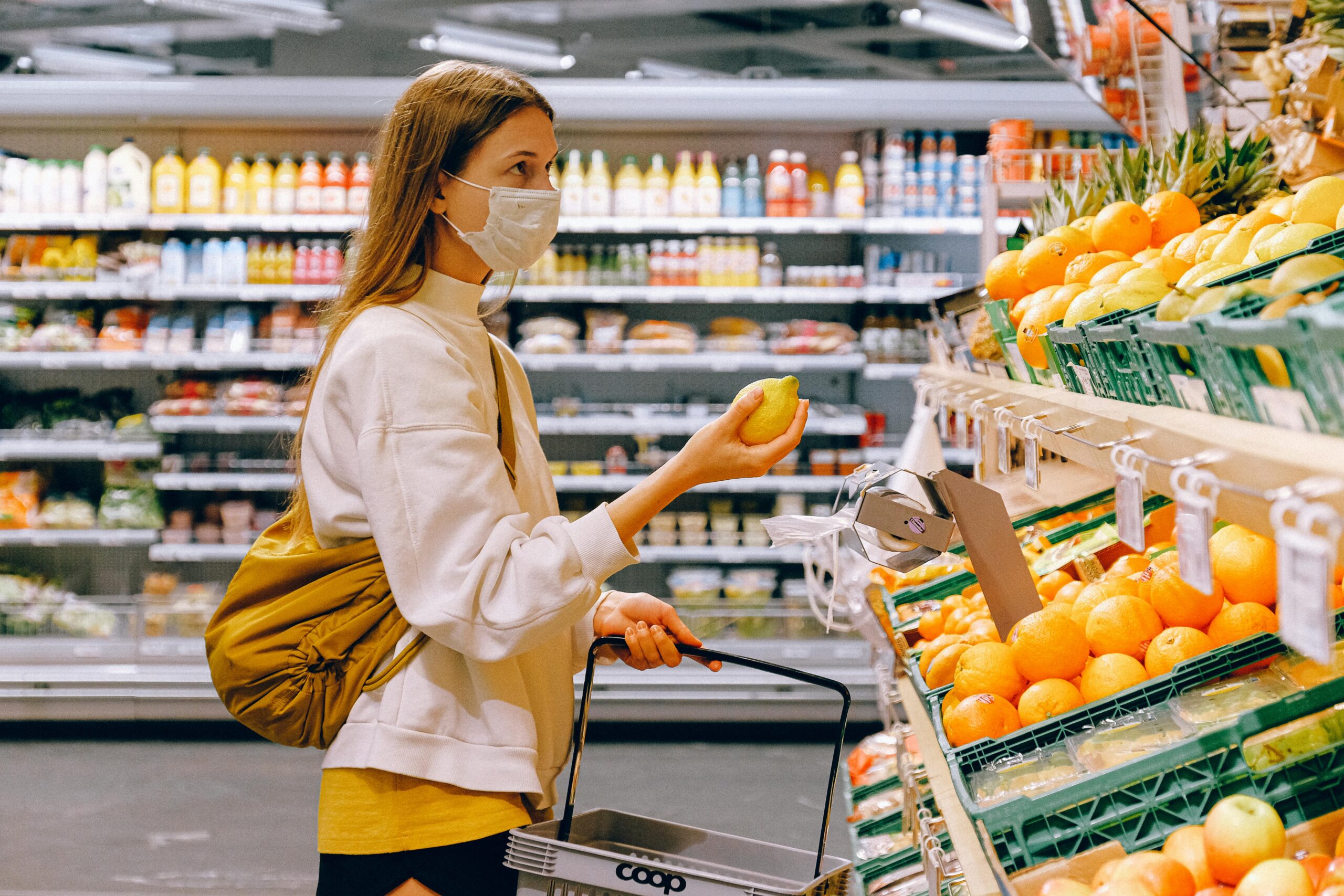 women purchasing lemon from super shop